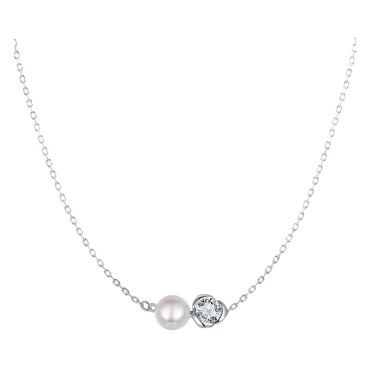 Pearl necklace with a heart-shaped diamond pendant on a light gray background